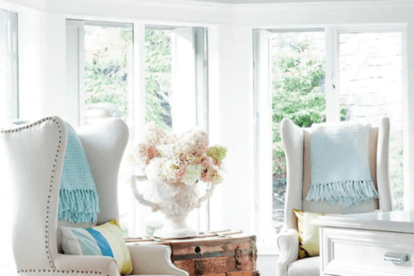 A photo of the inside of the Kelowna home once owned by Jillian Harris. It features white bow windows and a seating area.