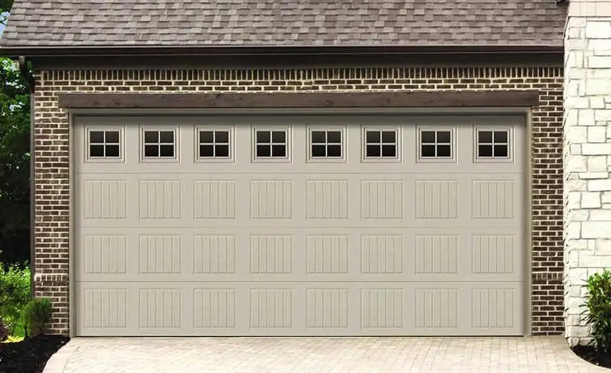 Speciality vinyl garage door in cream colour with windows across the top