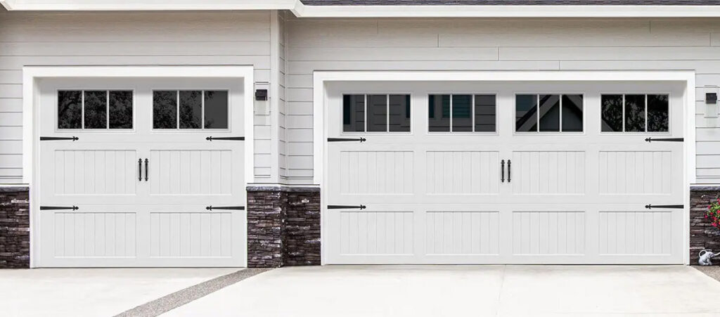 Designer steel double garage doors in white with window across the top and black arrow hinges.