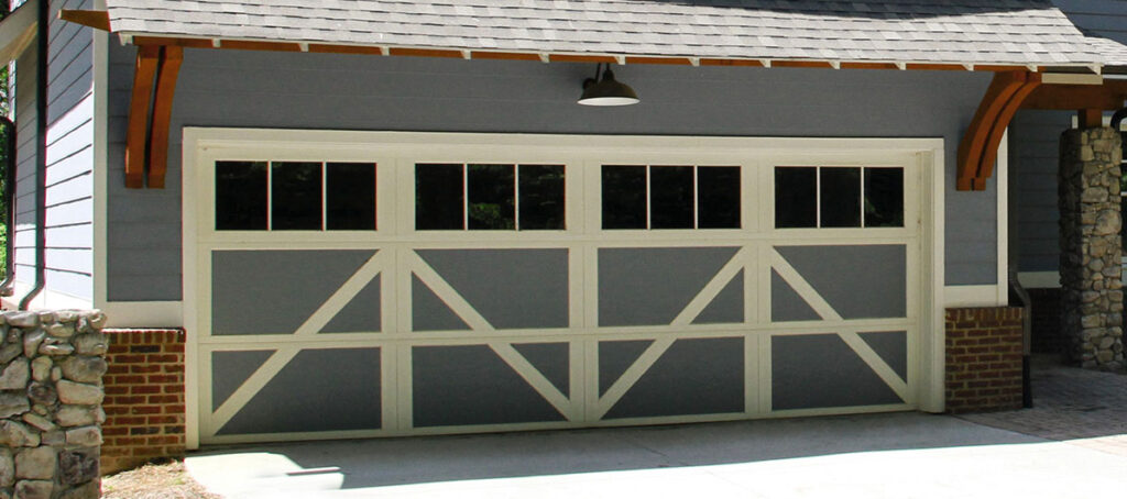 Carriage house garage doors in blue with white framing