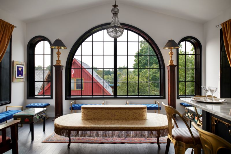 A photo of the inside of the Elora Distillery showing large and rounded industrial windows.