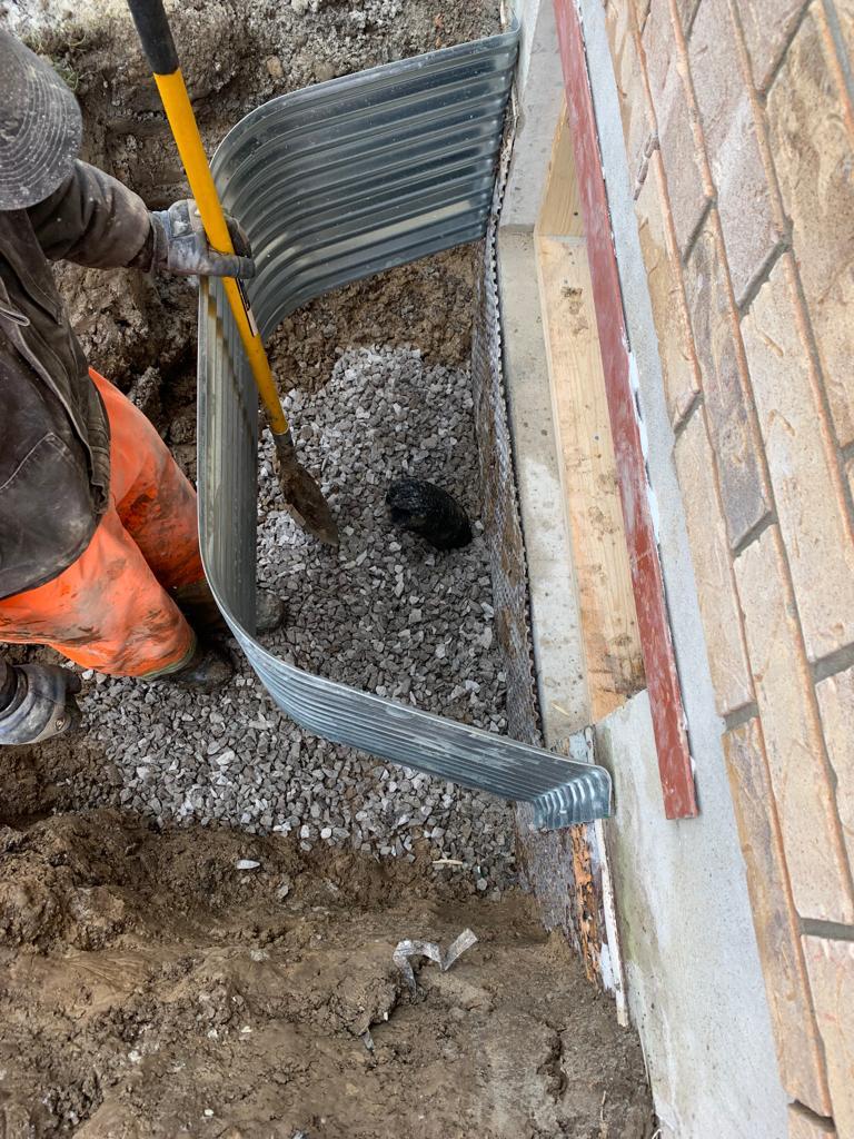 Person installing a window well